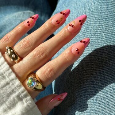 French manicure with cherry gemstones